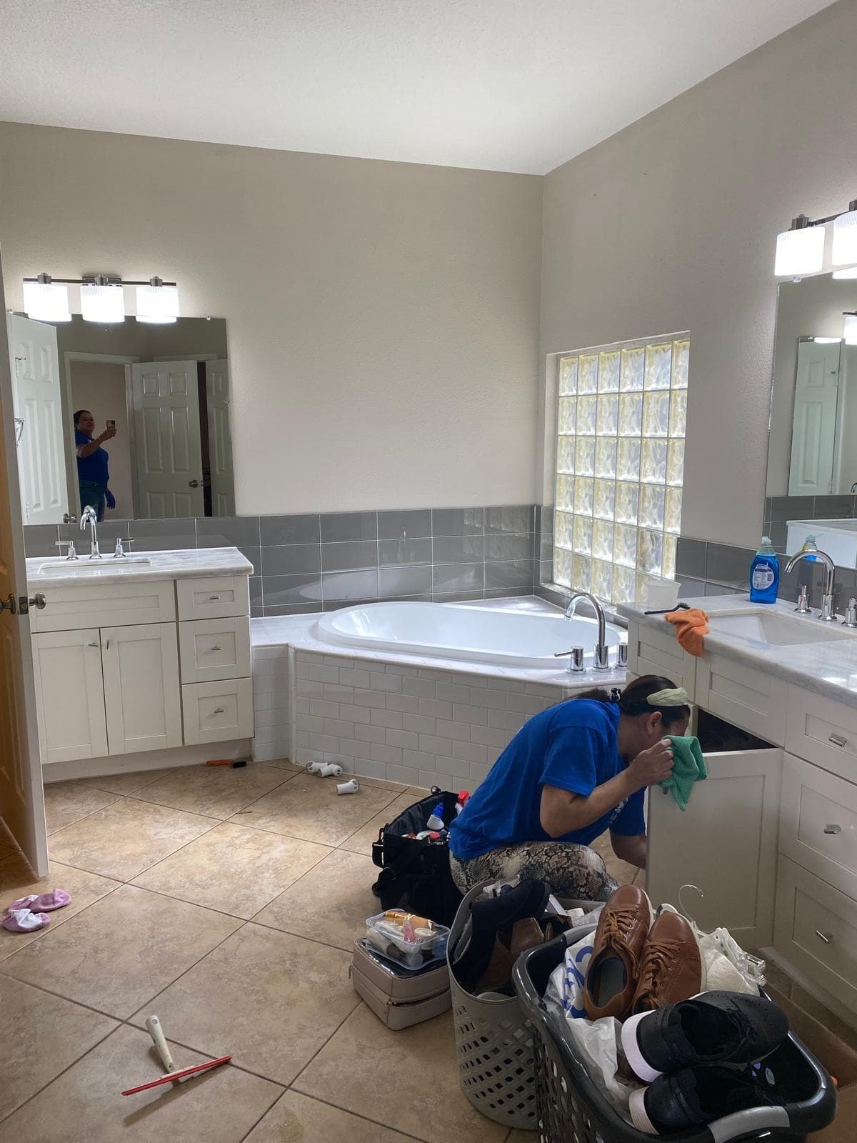 Professional cleaners finishing touches in a client kitchen